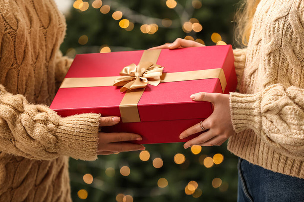 Vrouwen met kerst geschenkdoos thuis, close-up - Foto, afbeelding