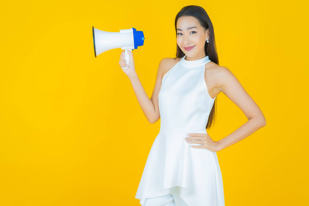 Ritratto bella giovane donna asiatica sorriso con megafono su sfondo di colore - Foto, immagini
