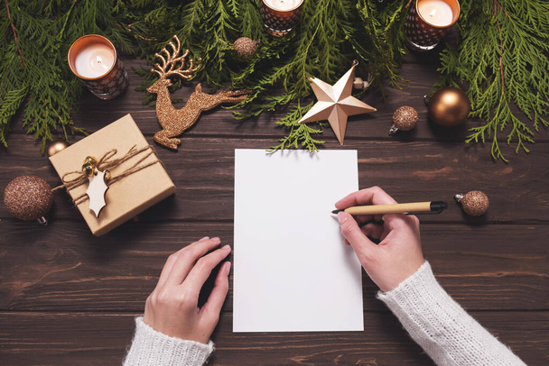 Goals plans dreams, make to do list for New Year. Woman hands holding pencil on empty paper. Christmas mockup. - Zdjęcie, obraz