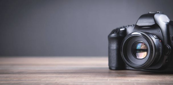 Professional DSLR camera on the wooden table. - Foto, immagini
