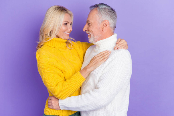 Photo of charming adorable mature wife husband wear knitted pullovers smiling embracing isolated purple color background - Valokuva, kuva