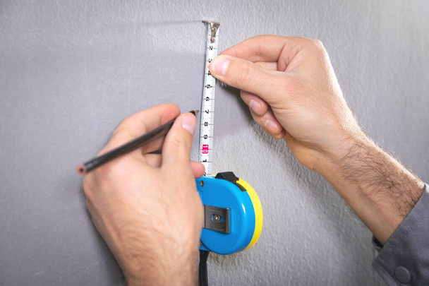Ruban à mesurer et marquage au crayon avec un mur. - Photo, image