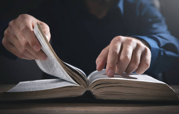 Caucasian man reading the Holy Bible. - Fotó, kép