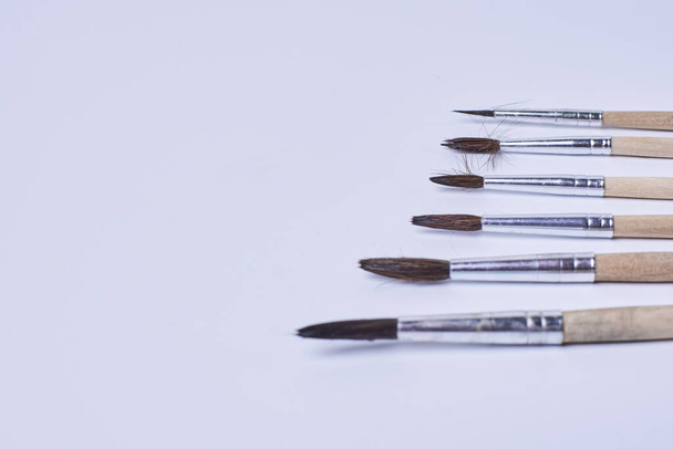 Various size painting brushes on white - 写真・画像