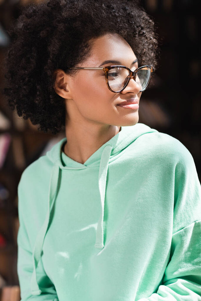 sunshine on face of curly african american student in eyeglasses  - Valokuva, kuva