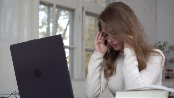 Moe vrouw met laptop. jong verdrietig vrouw student of freelancer zit in de voorkant van een computer - Video