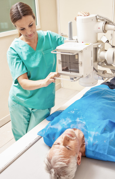 Xray machine. Female doctor analyzing senior male - Photo, Image