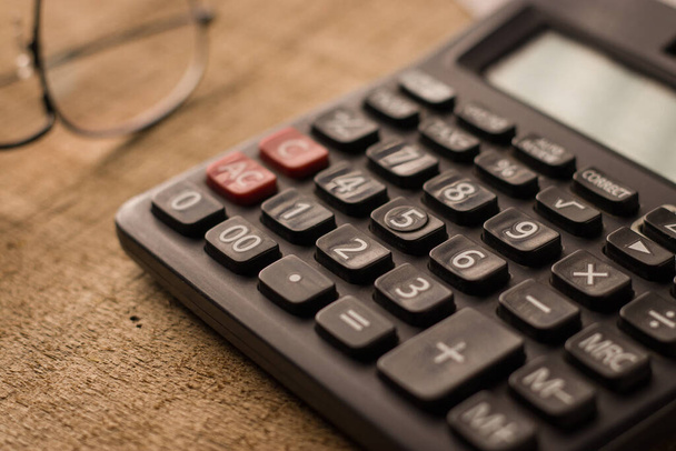 Black calculator on white background isolated stock image. - Φωτογραφία, εικόνα