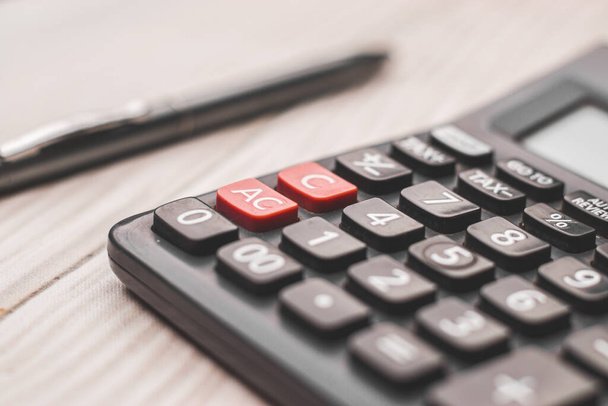 Black calculator on white background isolated stock image. - Foto, afbeelding