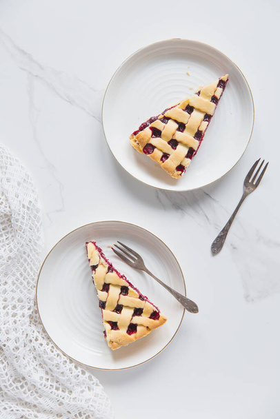 Slice of homemade cherry pie with on white background. - 写真・画像