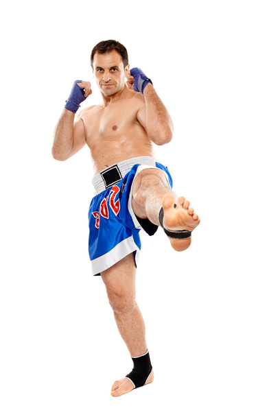 Kickbox fighter executing a kick - Fotó, kép