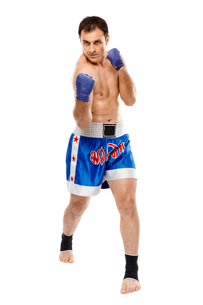 Kickbox fighter executing a punch - Foto, Bild