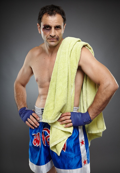 Bruised fighter with towel - Φωτογραφία, εικόνα