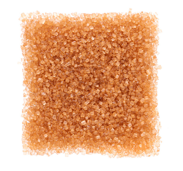 Brown sugar isolated on white background. Heap of cane sugar crystals. Top view. - Photo, Image