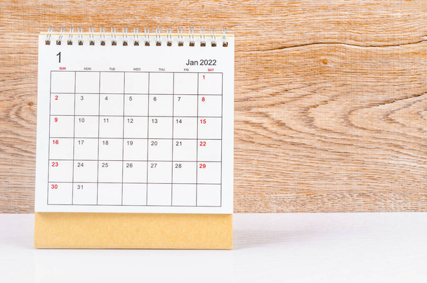The January 2022 desk calendar on wooden background. - Fotoğraf, Görsel