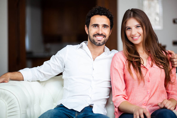 Young couple on the sofa at home  - 写真・画像