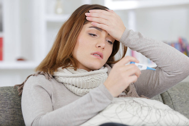 ill young woman with fever spending time at home - Photo, image