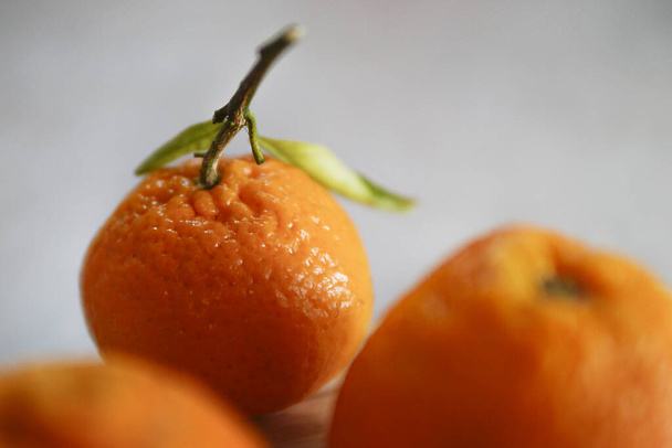 The fresh mandarins on the wooden table - 写真・画像