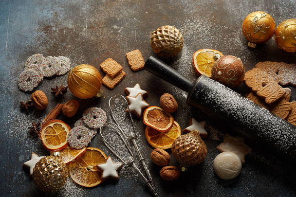 Christmas cookies, baking tools, and baubles on the table - Fotografie, Obrázek