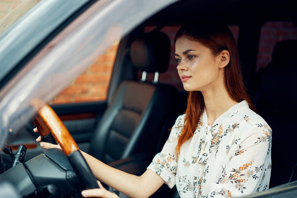 cute red-haired woman driving a car lifestyle trip - Foto, imagen