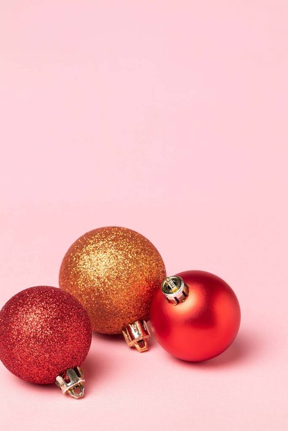 Red and gold Christmas balls decoration on red background. New Year party card. Minimal style. - Foto, immagini