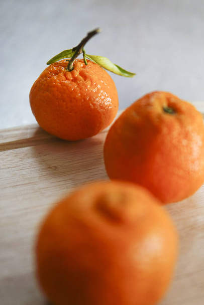 The fresh mandarins on the wooden table - 写真・画像