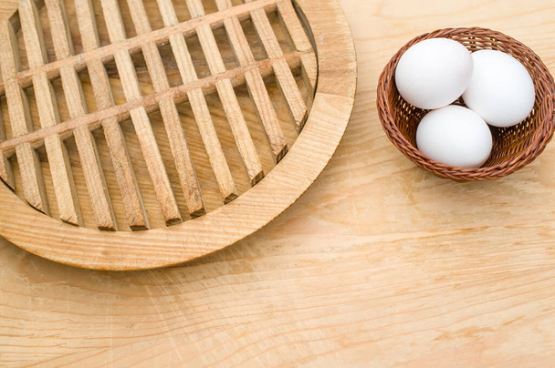 organic white eggs in a canister on a natural wooden tabletop surface with copy space for text - Fotoğraf, Görsel