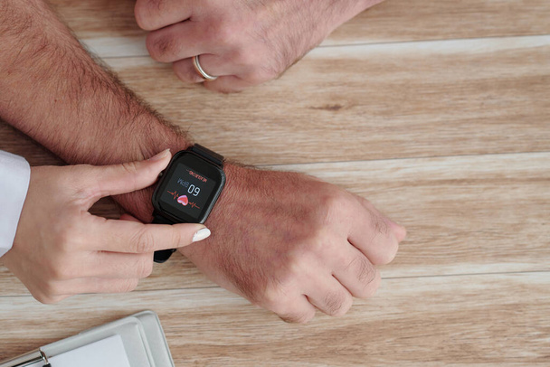 Doctor Explaining How to Use Smart Watch - Photo, Image