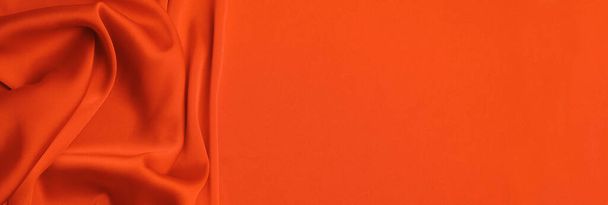 Orange silk fabric as background, top view with space for text. Banner design - Foto, Bild