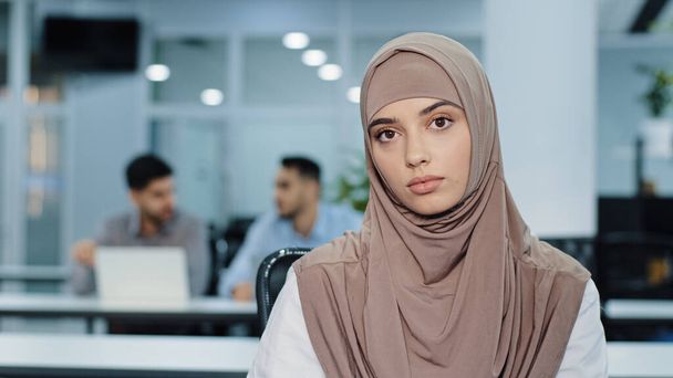 Porträt der angenehmen ernsthaften arabischen Geschäftsfrau im Hijab selbstbewusst Versicherungsmakler Bankmanagerin hr Assistentin im Großraumbüro Frau Blick in die Kamera einladend, bereit, Kunden zu helfen - Foto, Bild