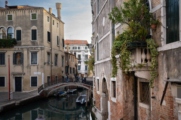 Venice, Italy - October 31, 2021: Small canal with gondola in Venice in winter - Fotoğraf, Görsel