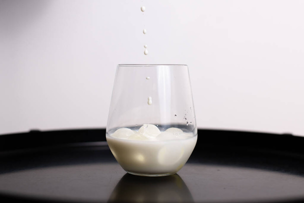 Pouring milk in a glass - Photo, image