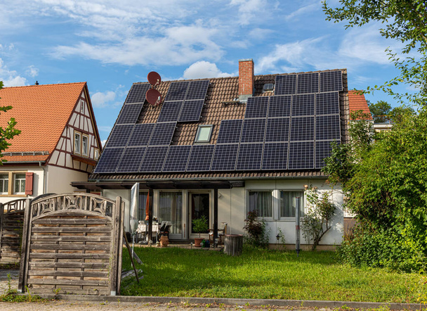 Single-family house in Germany with retrofitted photovoltaic solar system on the roof - Photo, Image