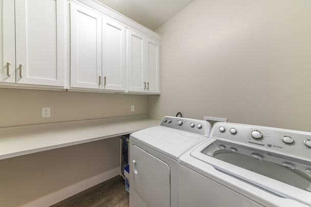 Interior of a laundry room with top cabinets and countertop - Photo, Image