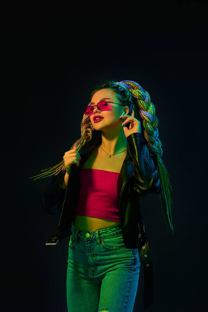 young woman with dreadlocks in red sunglasses dancing - Foto, imagen