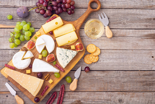 Cheese board with fruits and snack . delicatessen food background - Valokuva, kuva