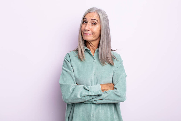 middle age gray hair woman looking like a happy, proud and satisfied achiever smiling with arms crossed - Photo, image