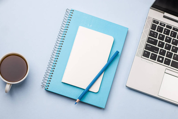 Empty notebook ready for mockup on blue table, top view, flatlay. - Фото, зображення