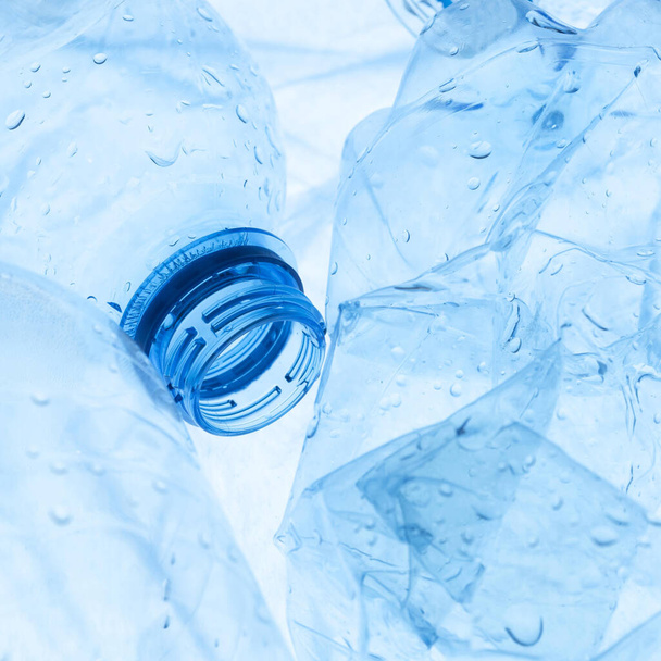 青いペットボトルとその廃棄物 - 写真・画像