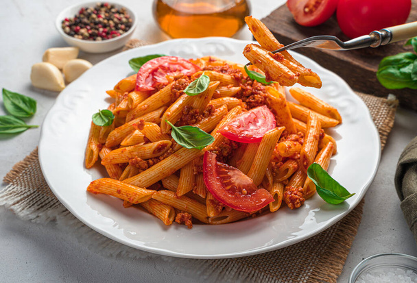 Penne pasta with bolognese sauce close-up. Side view, close-up. Italian cuisine. - Fotó, kép