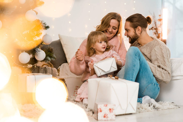 Happy family looking at christmas gifts - Photo, Image