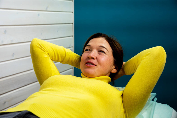 A young woman practices the technique of kinesiology. Chiropractic treatment, Back pain relief. Physiotherapy for female patient, Kinesiology. Smiling female face. - Photo, Image