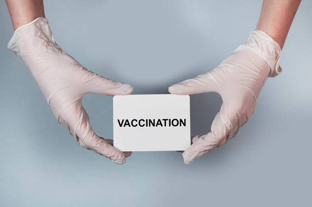 Vaccination word on paper in hand in glove - Foto, immagini