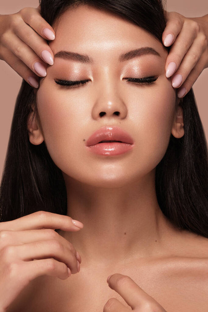 Beautiful delicate woman of oriental type with nude makeup and perfect skin. Beauty face. Spa - Fotoğraf, Görsel