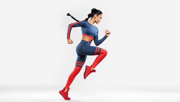 Runner running isolated on white background. A strong athletic, women sprinter wearing in the sportswear, fitness and sport motivation. Run concept with copy space. Dynamic movement - 写真・画像