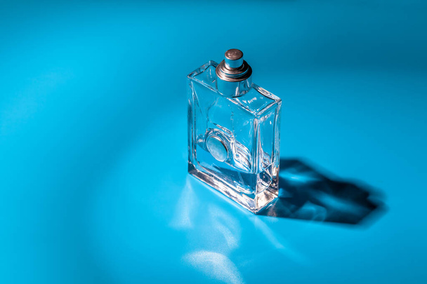 perfume glass bottle on light blue background. Eau de toilette - Fotoğraf, Görsel
