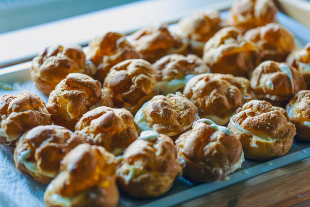 The iconic cream puffs, beloved pasterie filled with vanilla. - Photo, Image