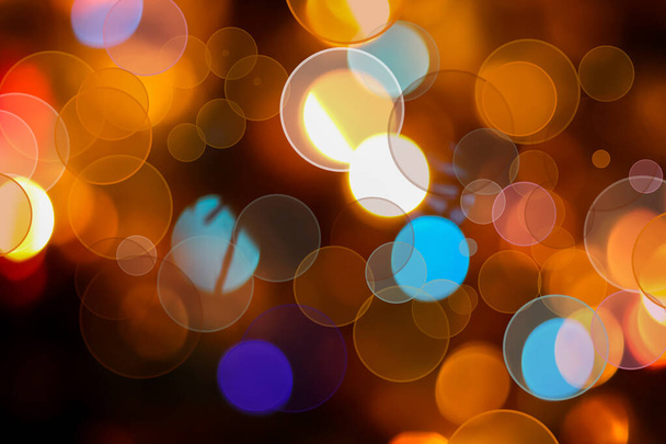 Abstract bokeh-style background on a dark background with multicolored circles. Concept: Christmas card, advertising banner, show, holiday, background, screensaver, wallpaper. - Foto, immagini