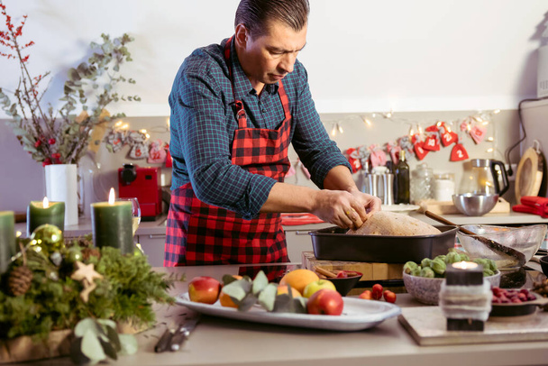 Man preparing delicious and healthy Christmas duck in home kitchen - Foto, Imagen