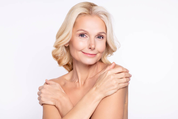 Portrait of attractive dreamy healthy grey-haired woman touching shoulders domestic wellbeing isolated over white color background - Zdjęcie, obraz